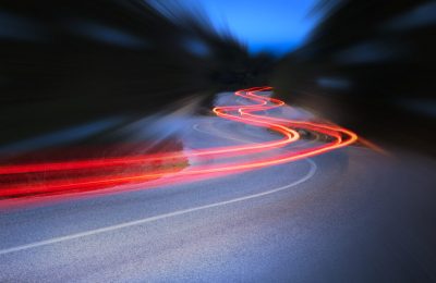 Panoramic - Cars light trails at night in a curve  asphalt road at night, long exposure image